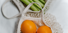 orange and celery in a net bag