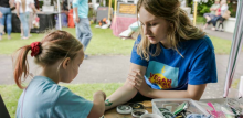 child painting on someone's arm