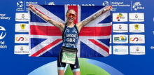 Vegan athlete, Lisa Gawthorne, in first place holding up UK flag