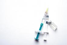 Covid-19 vaccine needle on white background
