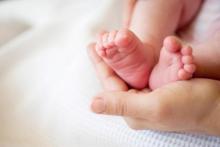 Mother holding baby feet
