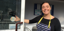 woman standing outside a cafe