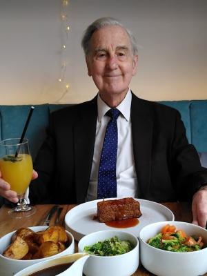 Gil Osman sitting down with a vegan dinner