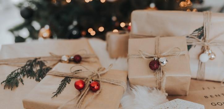 wrapped Christmas presents next to Christmas tree