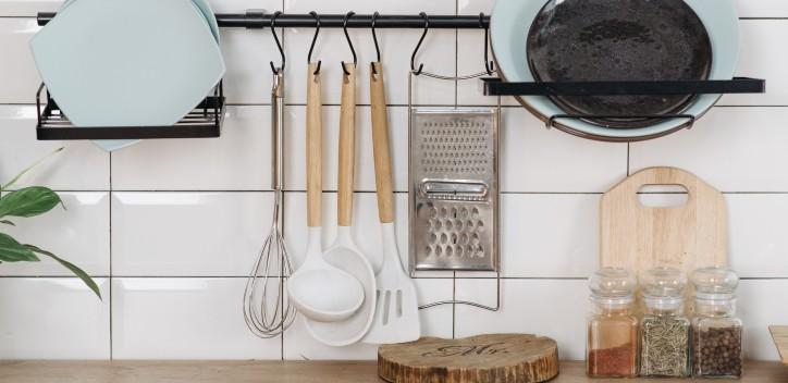 Small kitchen with plates and hanging utensils