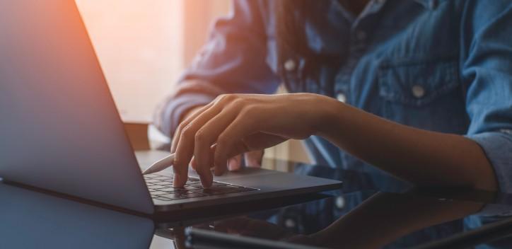 person typing on laptop