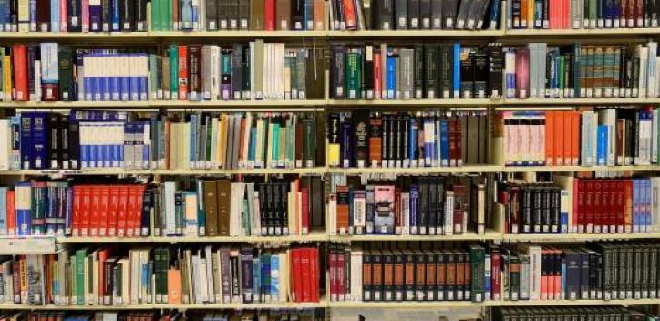 A row of book shelves from floor to ceiling.