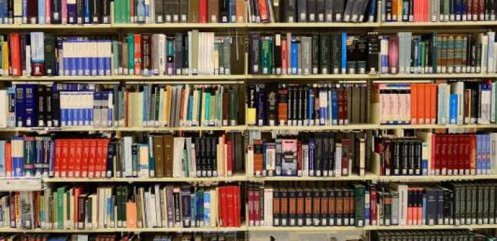 A row of book shelves from floor to ceiling.