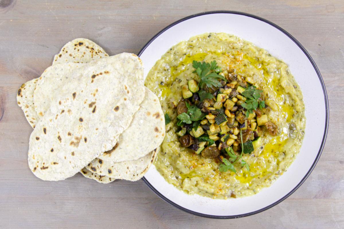 vegan flatbread with baba ganoush on a grey wooden background