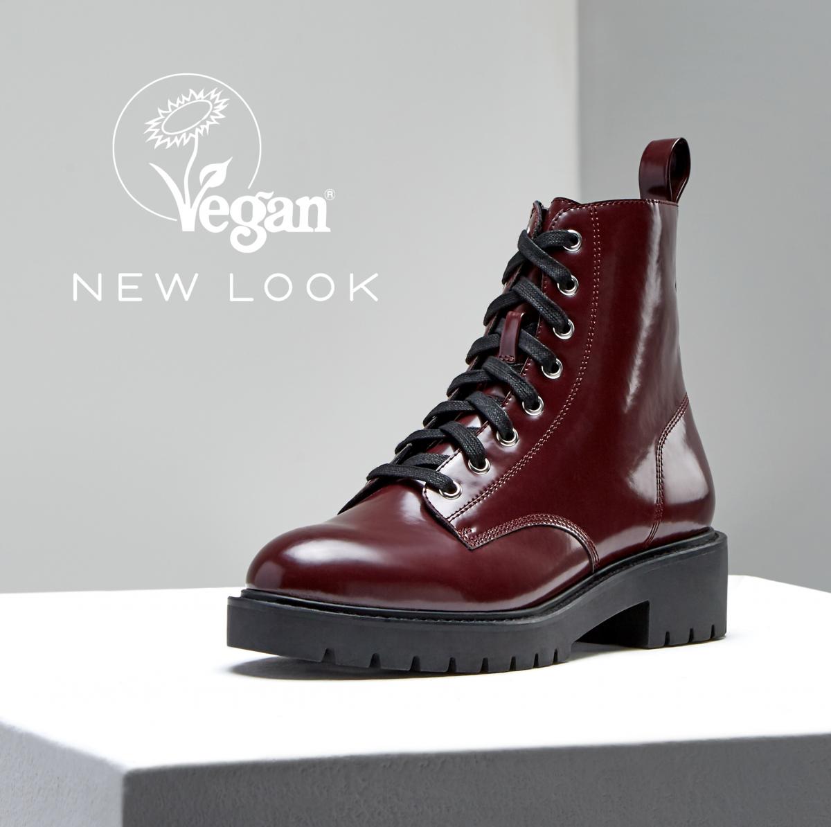 Dark red winter vegan boot against a grey background