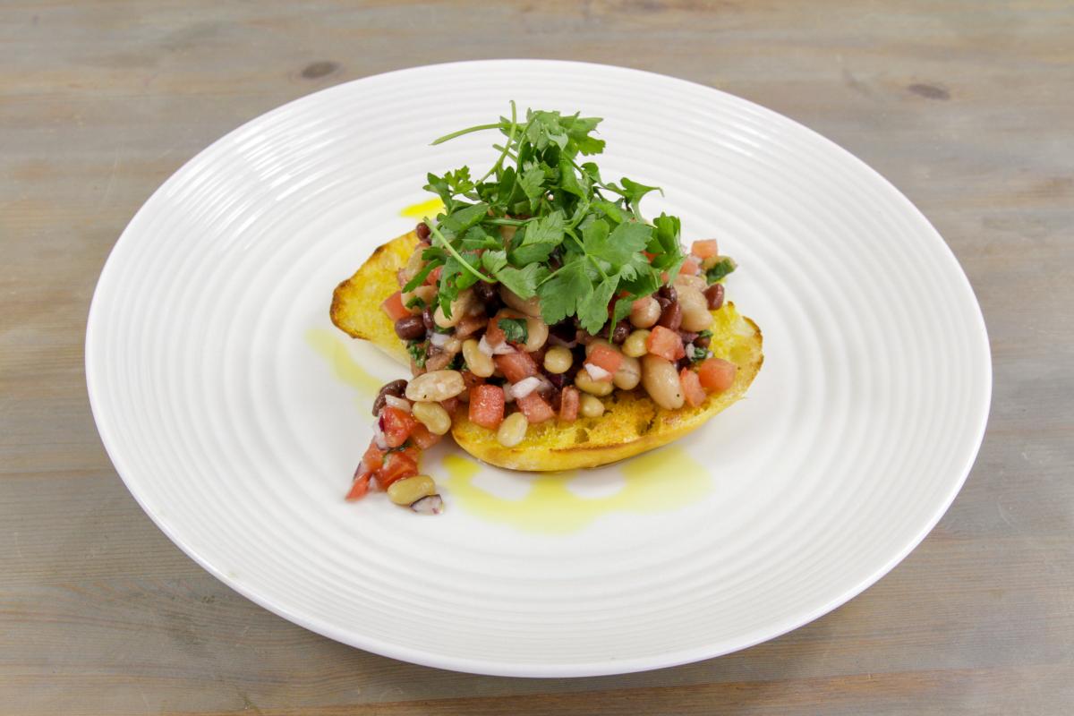 vegan simple bruschetta with yellow oil drips and rocket salad