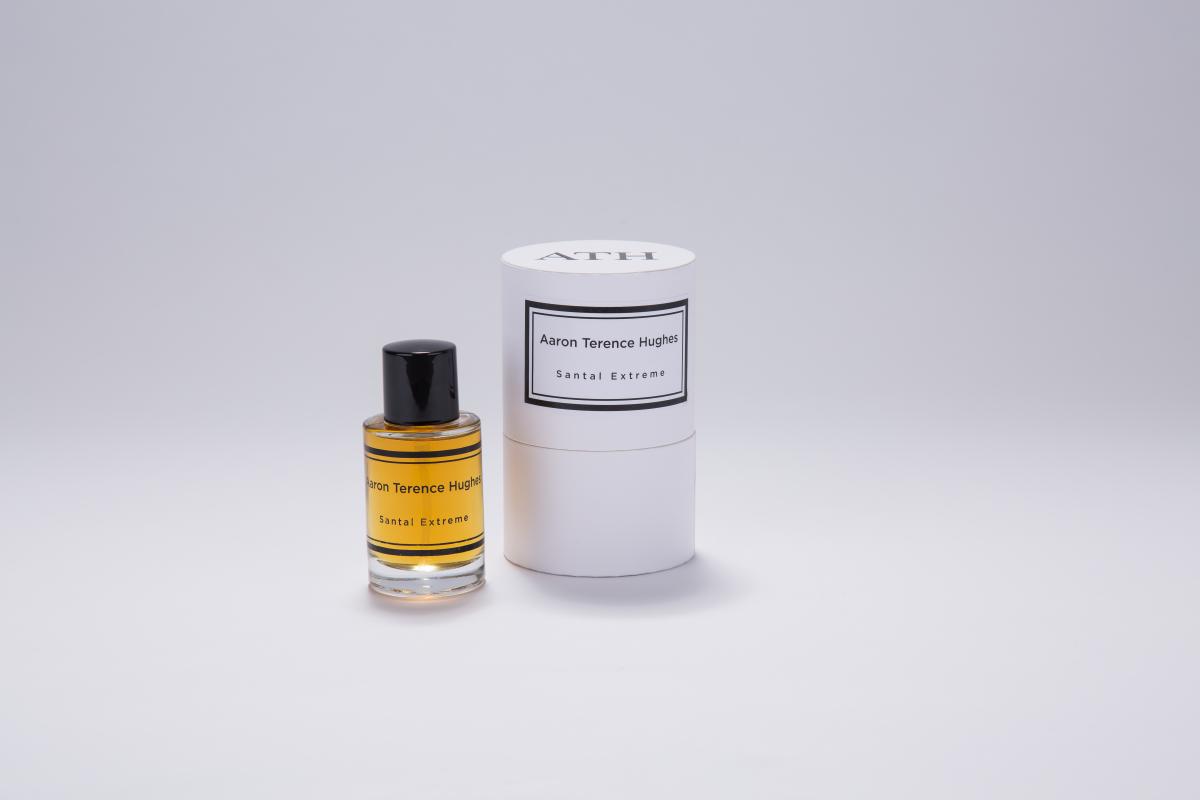 Perfume bottle next to box against a neutral background