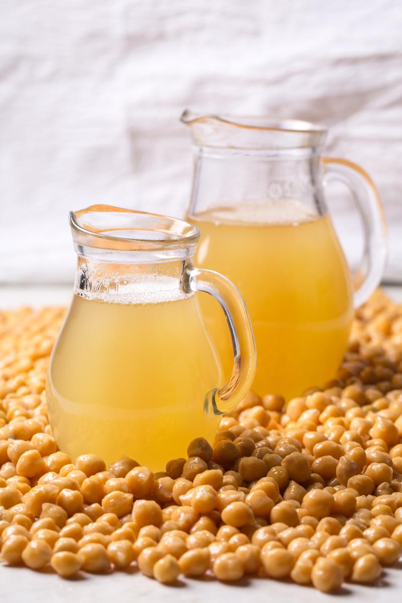 photograph of chickpeas with jug of chickpea juice