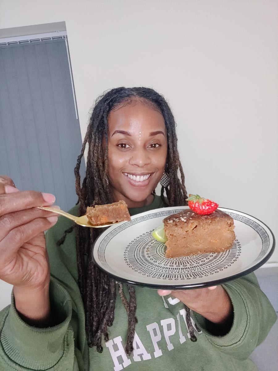 Ital Alex holding up sweet potato pudding