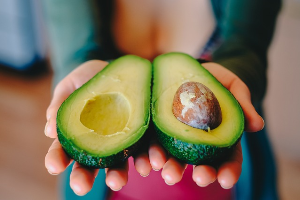 An avocado cut in half: a great inclusion into your balanced and varied diet