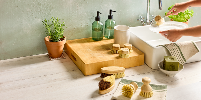 Person washing dishes using the bamboo brushes