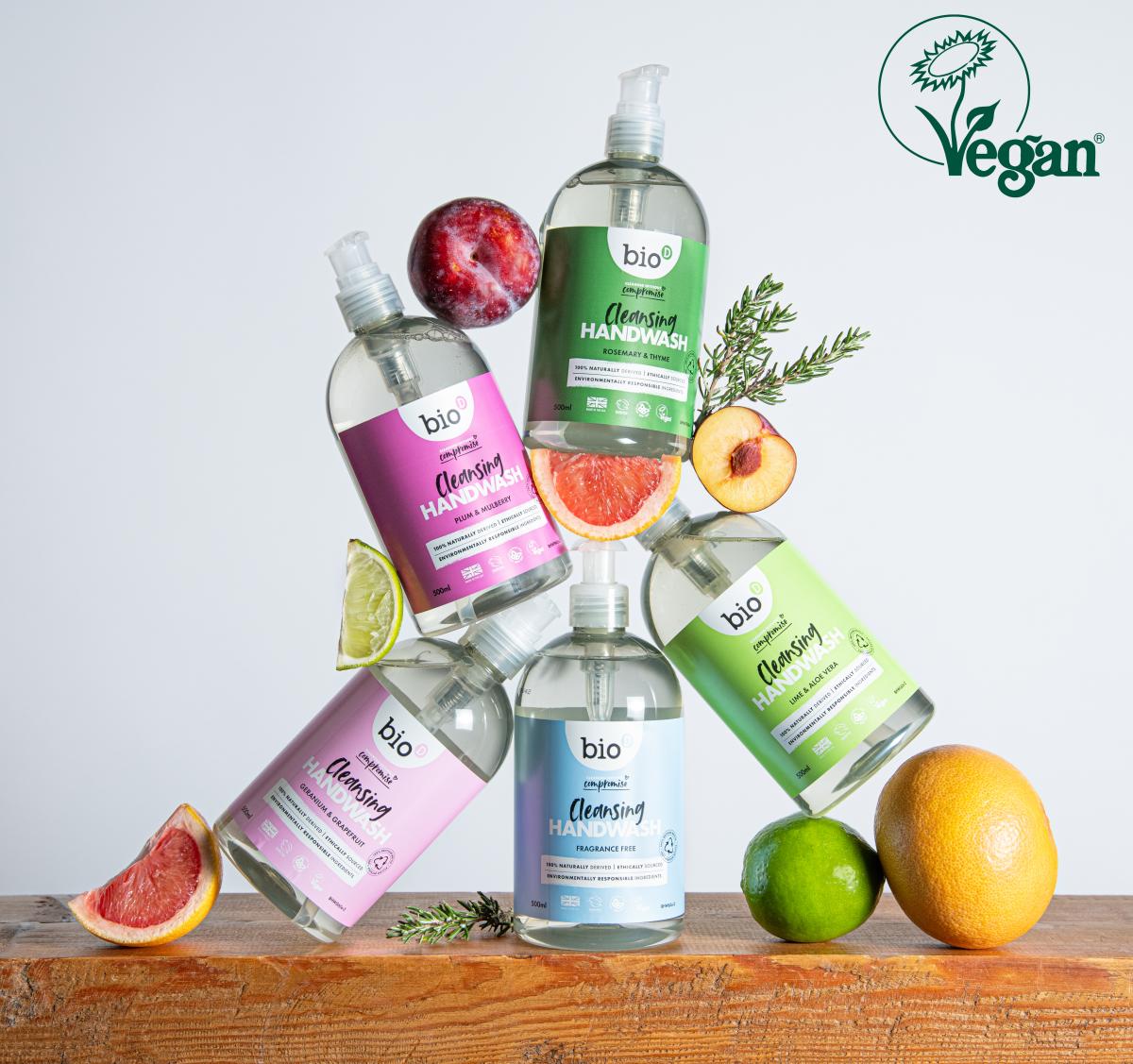 Bio-D cleansing handwash stacked together surrounded by fruit, with the Vegan Trademark displayed