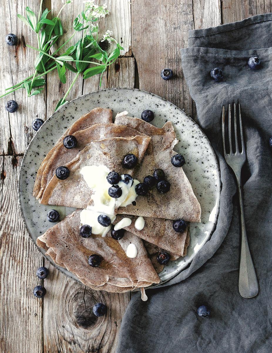 Buckwheat crepes presented on a plate with blueberries