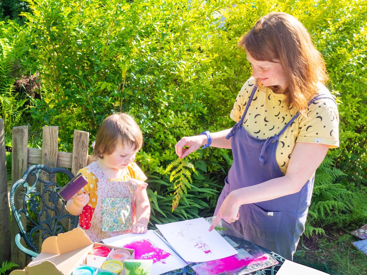 Rebecca and her daughter painting outside