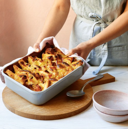 Lady making bread and butter pudding