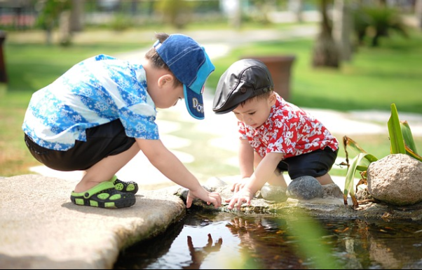 Two young children playing together. Childhood is a great time to introduce healthy eating patterns.