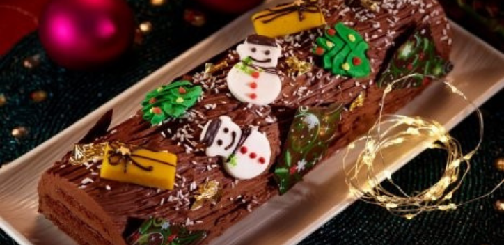image of a festive chocolate log with decorations of snowmen, christmas trees and presents 