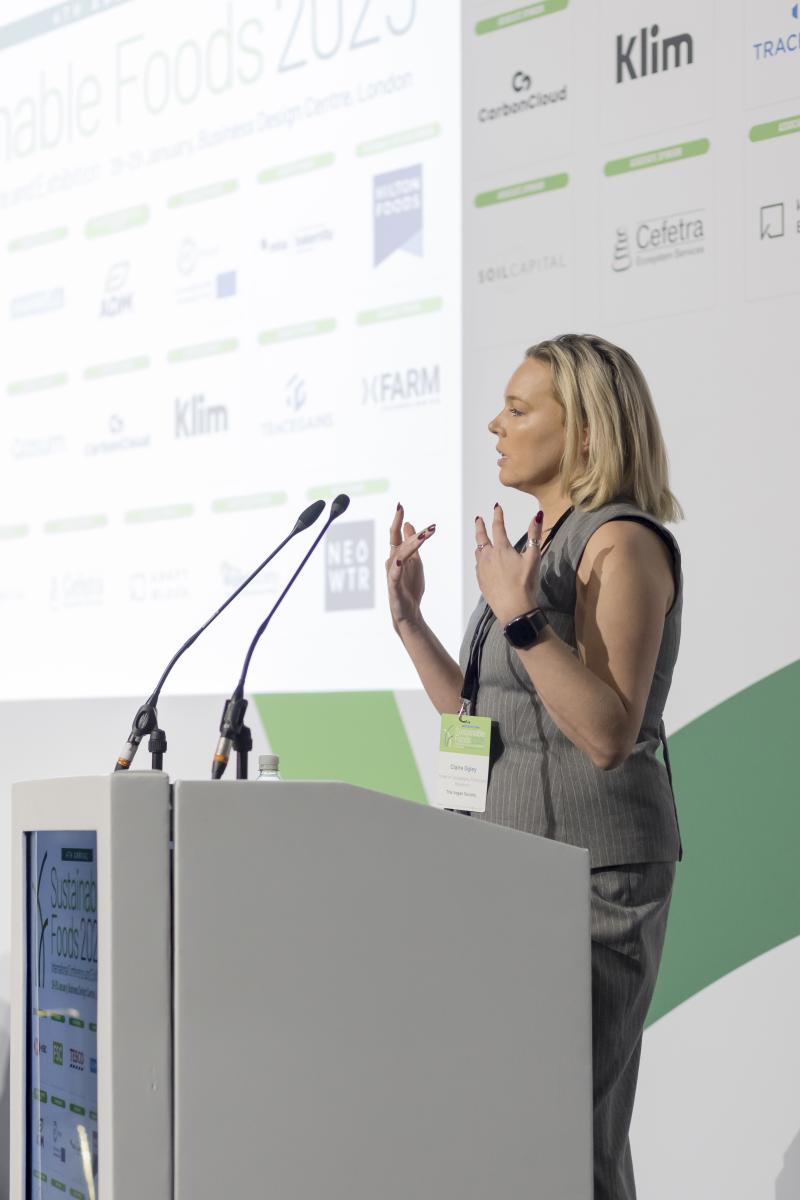 Claire Ogley, delivering speech at a podium at Sustainable Foods 2025 event