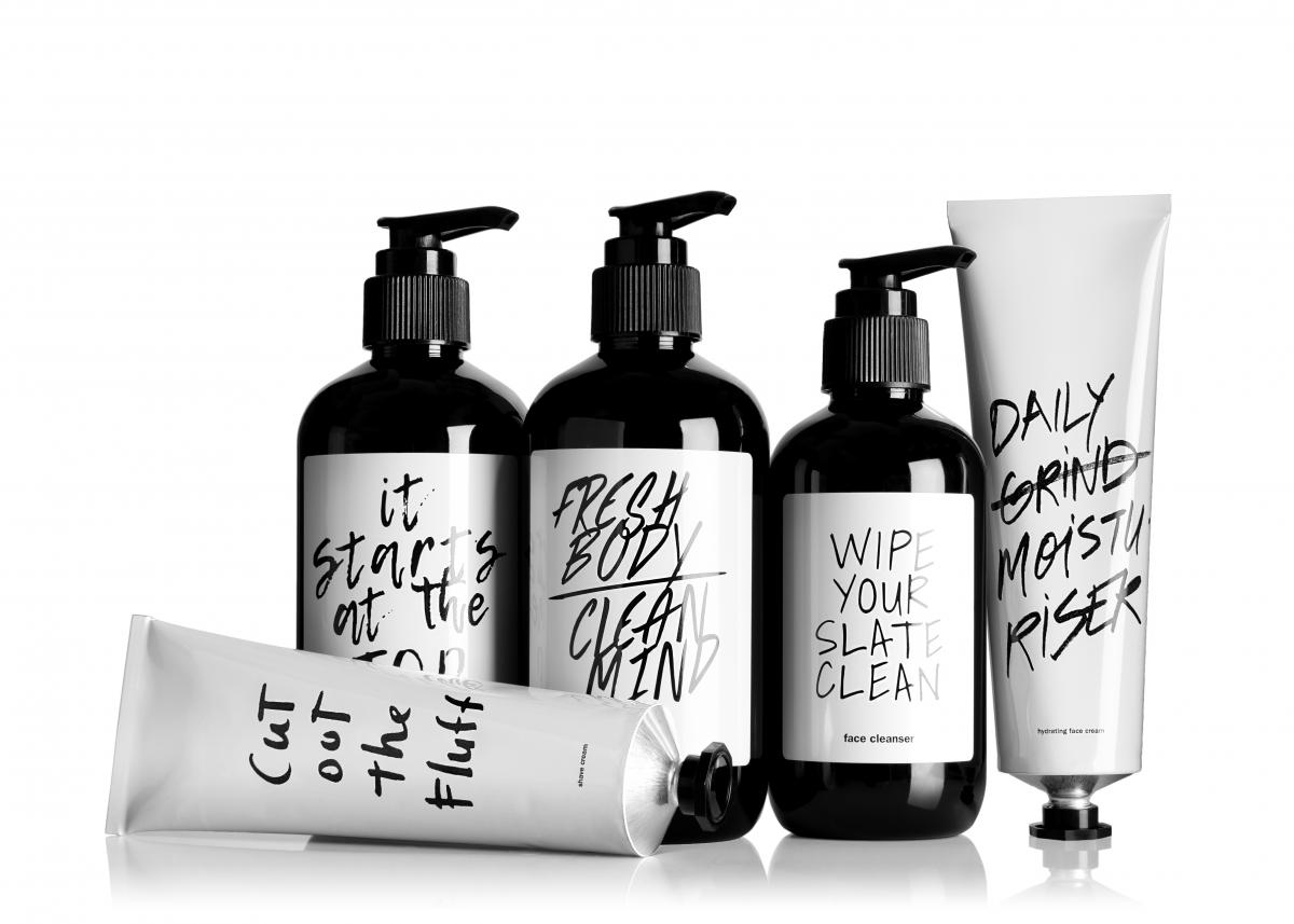 Five bottles with black and white packaging against a white background