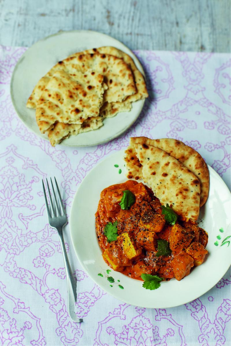Vegan Tofu tikka masala by Fearne Cotton with naan bread on a white and purple patterned cloth