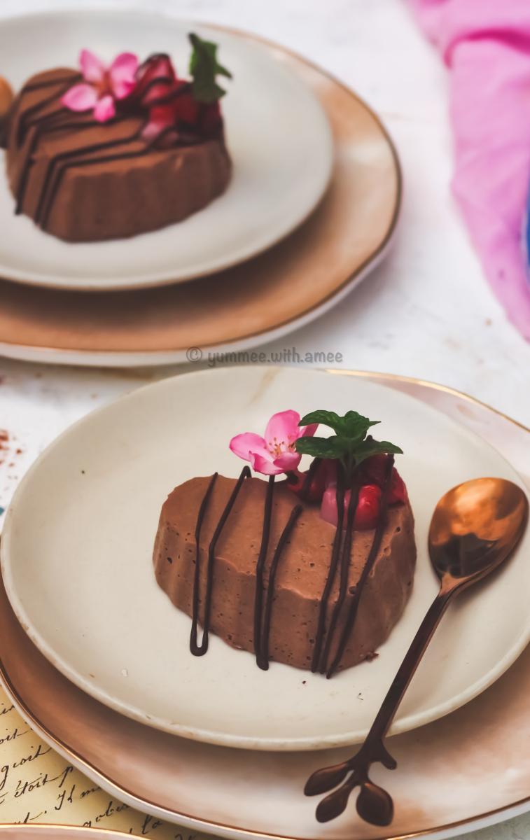 Mocha panna cotta hearts served on a dish with edible flowers