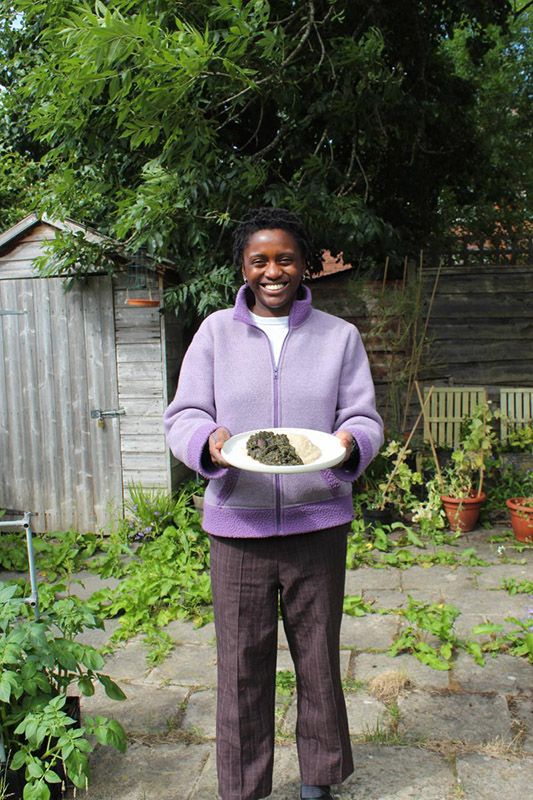 Ngwafu Tansie standing outside holding food