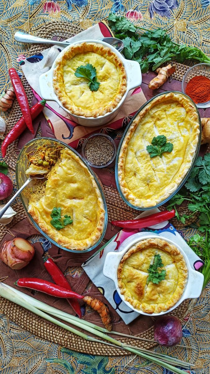 Opor Nangka (Jackfruit Coconut Pot Pie) served on a dressed table surrounded by chilli's and garnishes