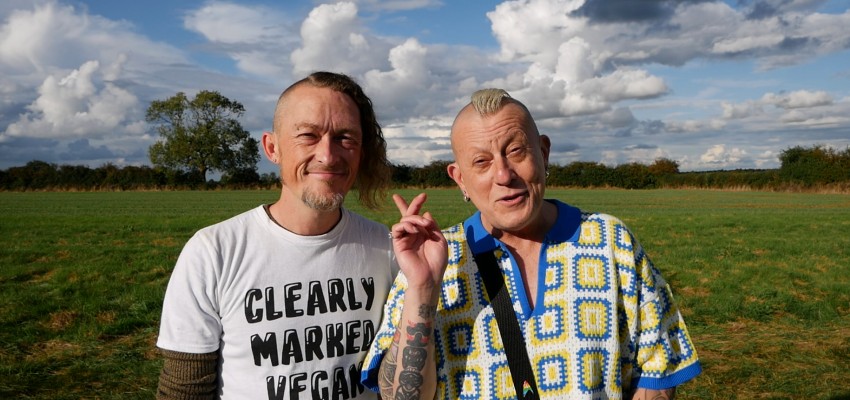 Vegan LGBTQIA+ influencers Paul and Jason standing together outdoors