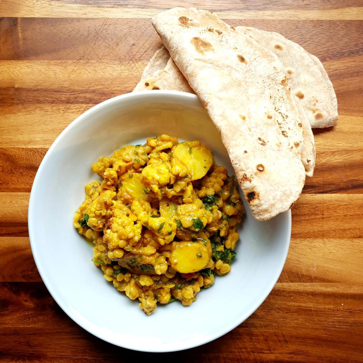 A portion of the vegan curry with naan