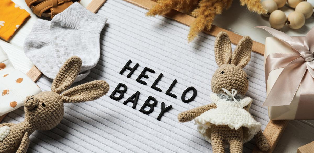 Vegan Pregnancy announcement with Hello Baby, teddies and baby clothes
