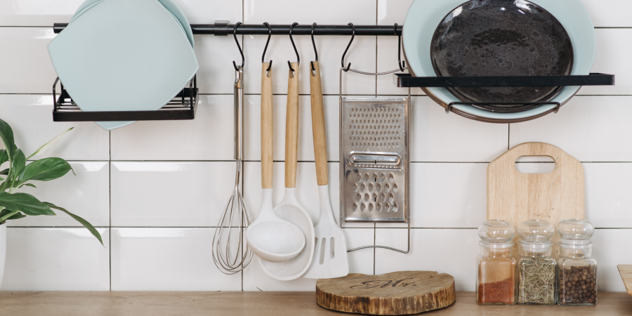 Small kitchen with plates and hanging utensils