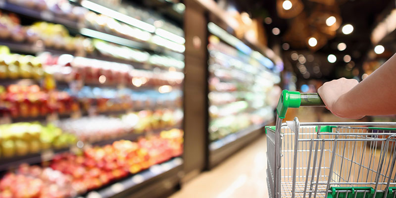 Person pushing a trolley in a supermarket