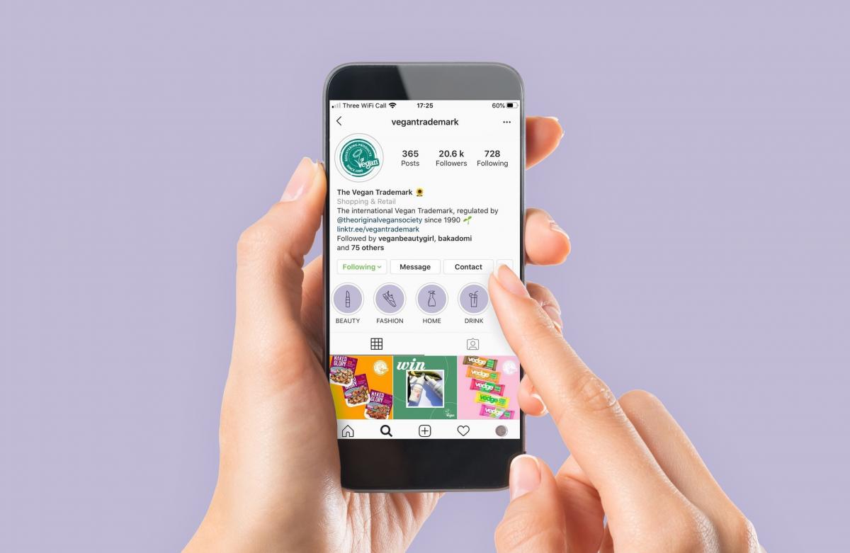 hand holding a smartphone with the Vegan Trademark Instagram open