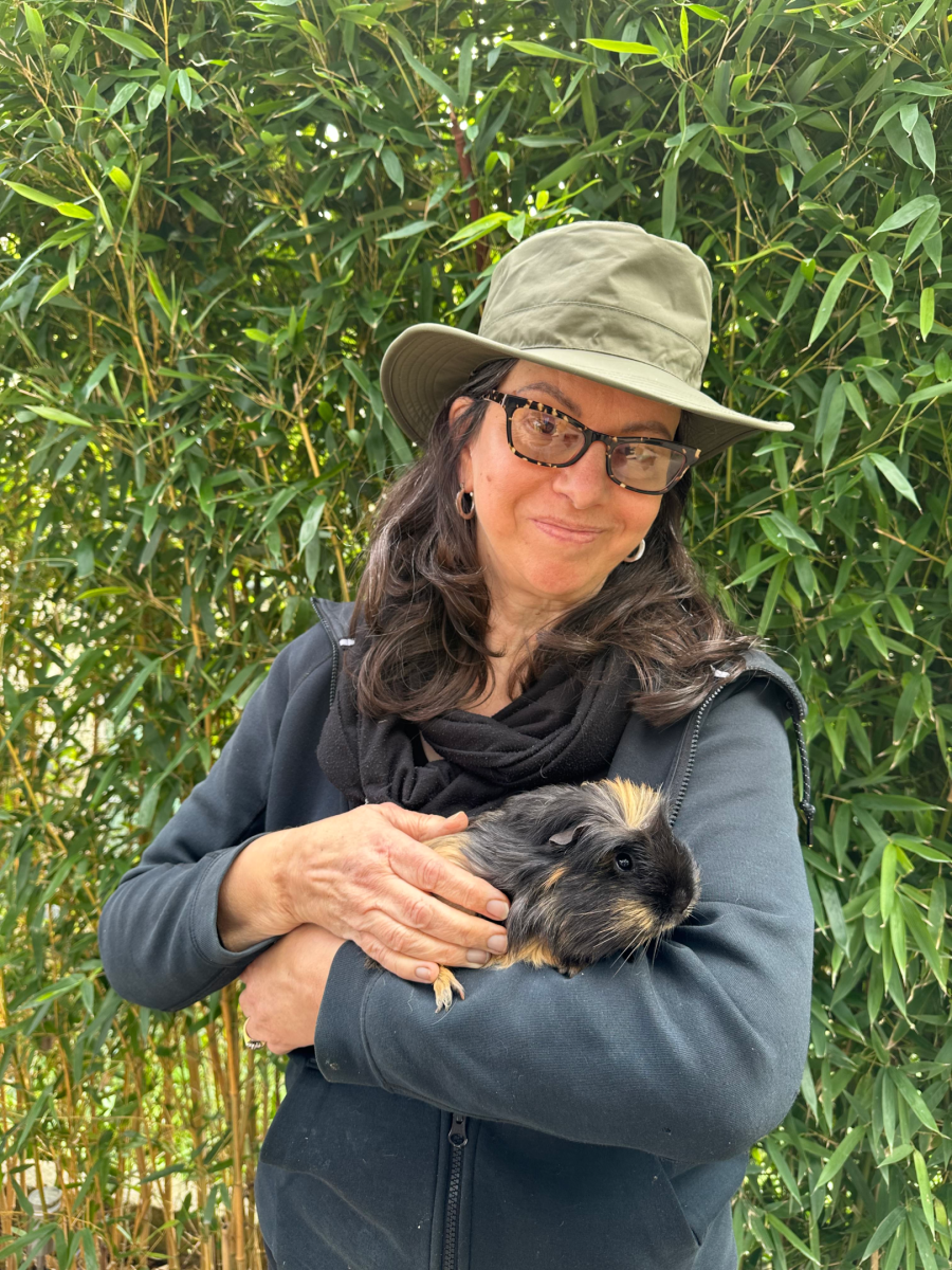 The Base Vegan Sanctuary staff member Jacqui, holding a guinea pig