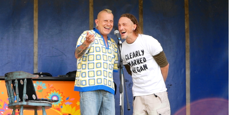 Paul and Jason on stage talking into a microphone