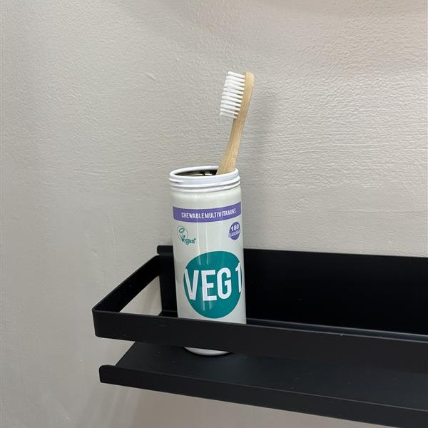 VEG 1 tin repurposed for a toothbrush holder