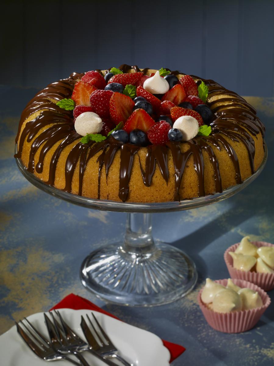 Vegan Celebration fruit cake served on a glass cake stand