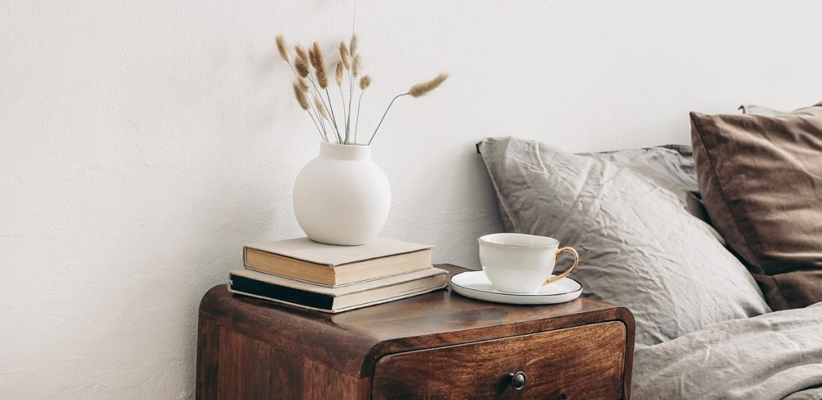 Bedroom bedside cabinet with books, case and a teacup