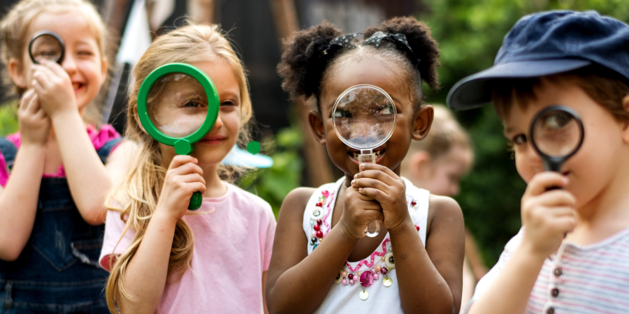 children holding up magnifying glasses
