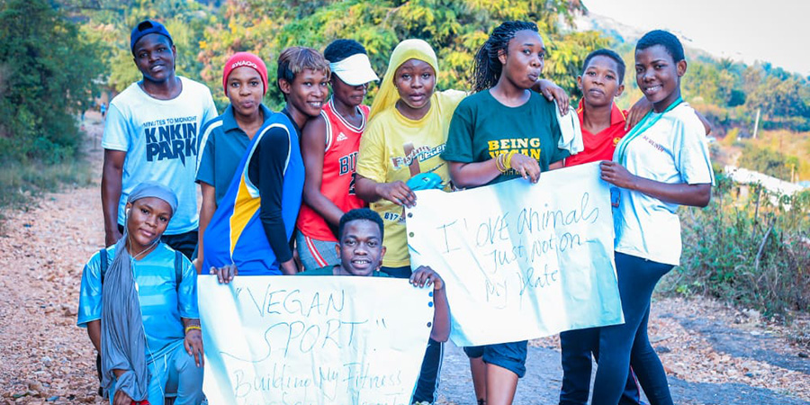 image of group from Bujumbura carrying out a vegan awareness campaign holding up signs
