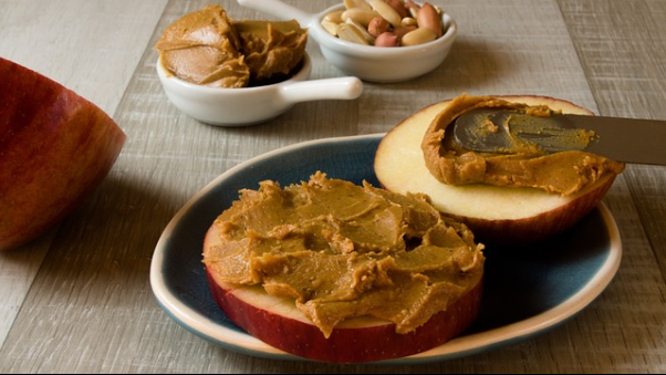 Peanut butter spread on a bagel