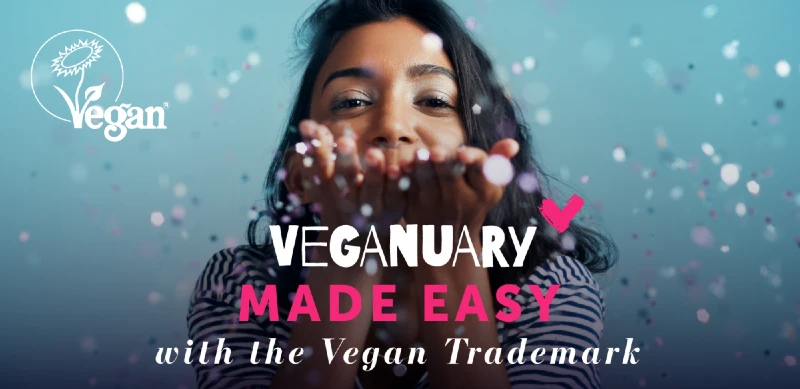 Girl blowing confetti towards camera with the words "Veganuary made easy with the Vegan Trademark"