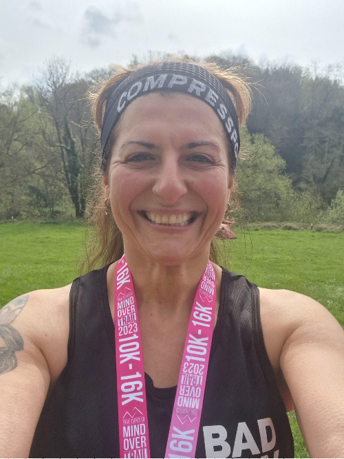 Wanausha wearing her running gear, smiling after completing a race