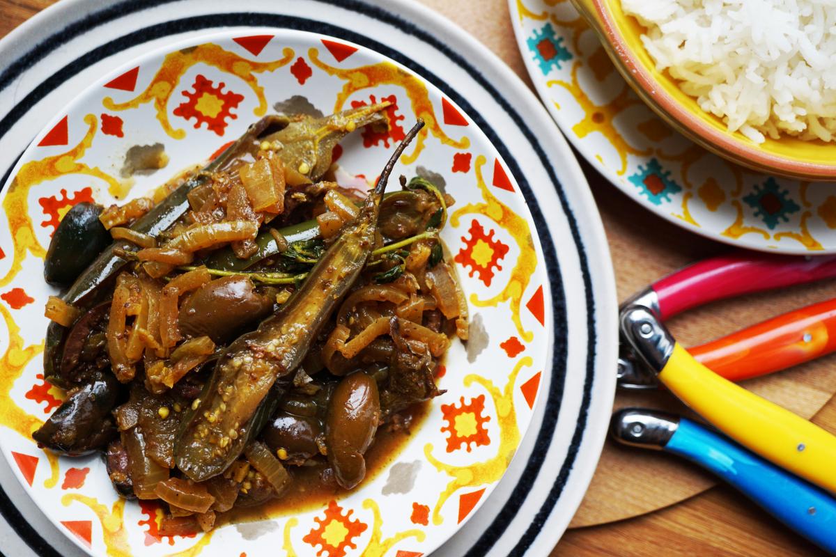 Aubergine, black olives and onion tagine stew served on a Morrocan styled plate.