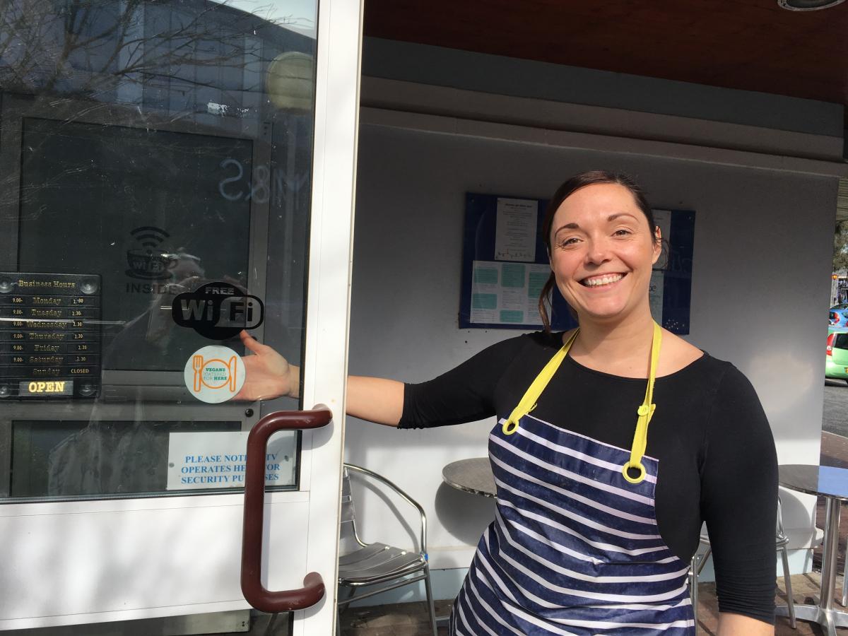 woman standing outside a cafe